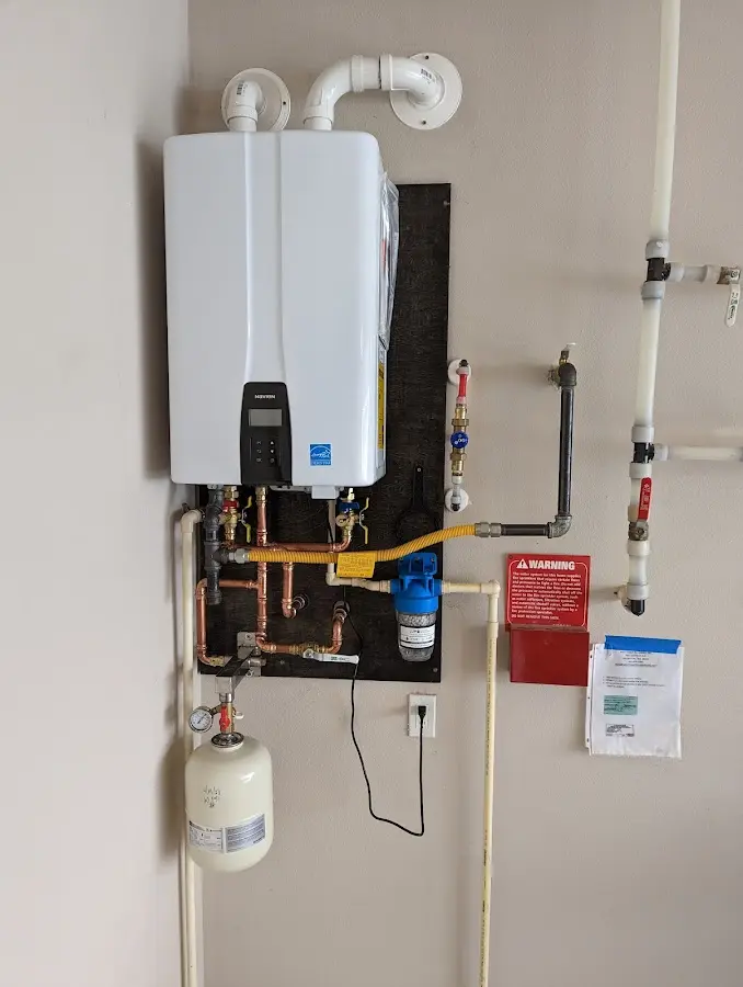 Professional plumber installing copper piping in a Oak Island home